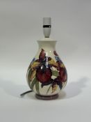 A Moorcroft baluster shaped table lamp decorated with red irises (marked verso) (h-32.5cm)