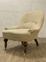 A Victorian walnut framed bedroom chair, in natural linen upholstery, raised on turned and fluted