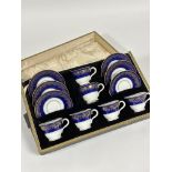 A Coalport china twelve piece coffee set comprising six coffee cups and sauces with royal blue
