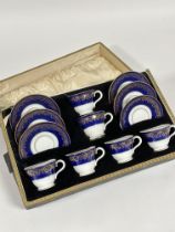 A Coalport china twelve piece coffee set comprising six coffee cups and sauces with royal blue