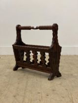A vintage stained and carved pine magazine rack. H47cm.