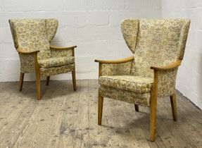 A pair of mid century Parker Knoll upholstered wingback chairs, with stained beech show frame,