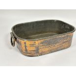A late 19thc copper zinc lined roasting dish of rounded rectangular shape with hinged handles to