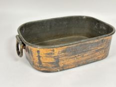 A late 19thc copper zinc lined roasting dish of rounded rectangular shape with hinged handles to