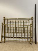 A Victorian gilt brass bed frame, the tubular head and foot moving on castors. H140cm, W154cm,