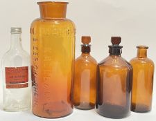 A group of five glass storage/Chemist's jars comprising four amber coloured jars including a German