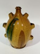 A 19thc French terracotta storage jar with three loop handles to side with golden honey and green