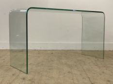 A modern rectangular plate glass consul table raised on twin end curved column supports