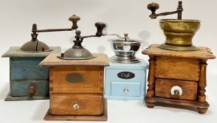 A group of four vintage coffee grinders, possibly continental, including two blue painted grinders a