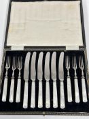 A set of six pairs of stainless steel bladed mother of pearl handled fruit knives and forks in