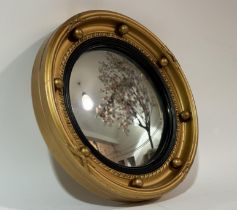 A gilt composition convex wall mirror. (24cmx24cm