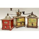A group of three French coffee grinders comprising two Japy Freres grinders decorated with rural sce