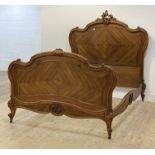 A Louis XV style French walnut double bed frame, late 19th century, the headboard of scrolling