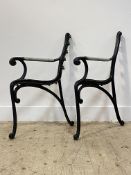 A pair of cast iron garden bench ends of scrolling form. H83cm.