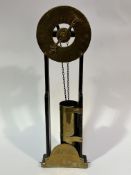 A 1920s reproduction R Mannin of Bath oak framed brass and copper water clock, the engraved dial and