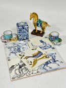 A mixed lot containing, a Delft tea caddy, a set of five Delft tiles, a miniature Tang style horse