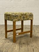 A mid century oak framed stool with upholstered top and raised on square section supports H45cm.