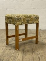 A mid century oak framed stool with upholstered top and raised on square section supports H45cm.