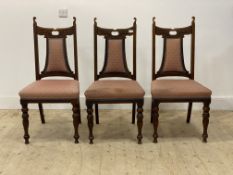 A set of three Victorian walnut dining chairs, with upholstered back and seat, raised on turned