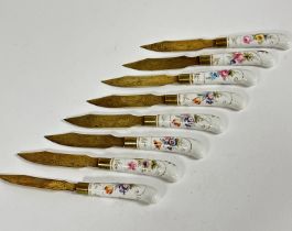 A late 19thc set of eight Stahl Bronce fruit knives with engraved blades and Meissen style porcelain