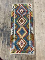 A Chobi kilim flat weave runner rug of characteristic design 148cm x 63cm