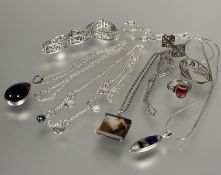 A collection of silver and white metal jewellery including two amethyst drop pendants, silver