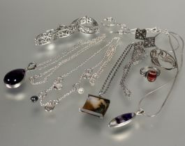 A collection of silver and white metal jewellery including two amethyst drop pendants, silver