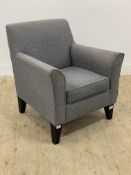 A modern easy chair upholstered in grey fabric raised on square tapered supports