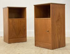 A pair of mid century teak bedside cabinets, each with an open shelf over a cupboard. H69cm,