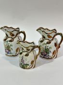 Two Victorian ironstone Wesley Powell  copper luster moulded jugs decorated with enamel decorated