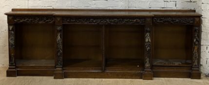 A Victorian oak dwarf breakfront bookcase, the ledge back and moulded top above a frieze carved with
