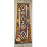 A Chobi kilim runner rug of geometric design 204cm x 65cm