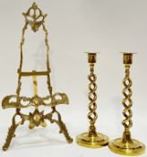 A group of brassware comprising an easel picture stand (h- 50cm) and a pair of twist stem candlestic