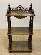 A Victorian burr and figured walnut three tier what not, the top with pierced gallery, and each