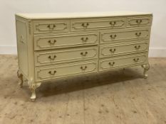 A French style cream and parcel gilt chest, fitted with a combination of nine drawers, raised on