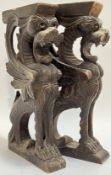 A pair of carved wooden wall mounts modelled as winged lions/griffins (h- 38cm, w- 21cm) (2)