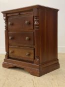 A stained cherry chest, fitted with three drawers enclosed by split pilasters, raised on bracket