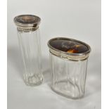 Two Birmingham silver tortoise inlaid topped dressing table jars with paneled sides, tallest top a/