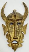 A cast metal wall mounted African style mask with horned helmet and Chamaeleon (h- 30cm)