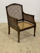 A Georgian style mahogany library bergere chair, early 20th century, with double cane arm panels,