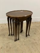 An early 20th century walnut nest of three tables with scalloped top and cabriole supports. H55cm,
