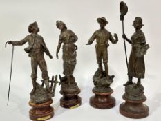 A pair of 19thc French spelter figures of a fisherman holding a spear and women holding a net and