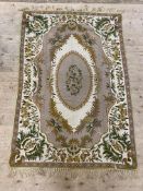 A Kashmiri hand stitch wool chain wall hanging or rug, with central medallion and ivory border