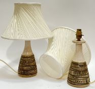 A pair of Poole Pottery lamp bases with abstract moulded/incised decoration and white shades (marked