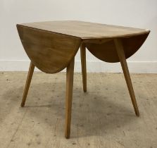 Ercol, an elm and beech drop leaf dining table, the oval top raised on square tapered supports.