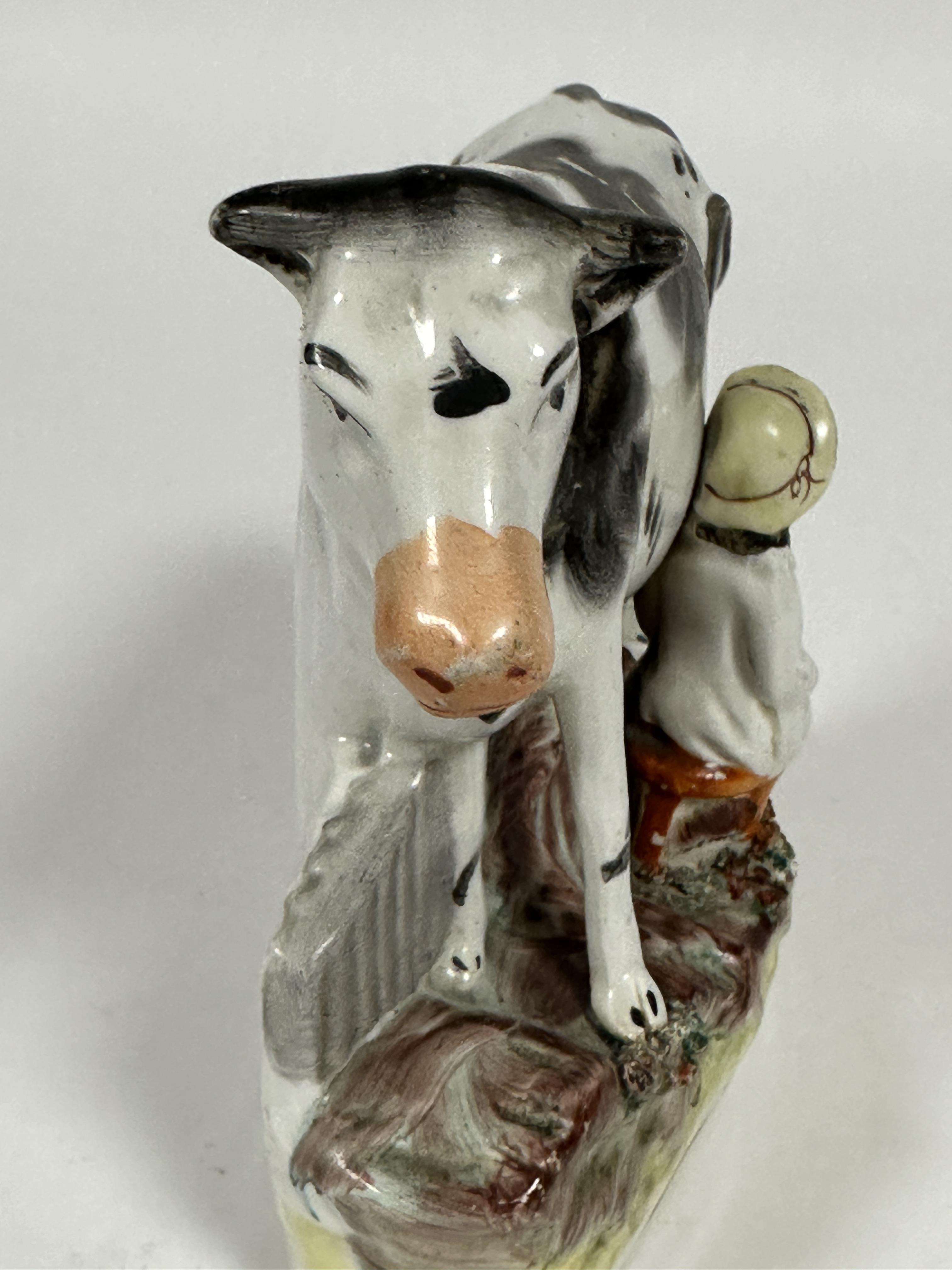 A 19thc Staffordshire china flatback group milking time with seated farmer decorated with polychrome - Image 3 of 3