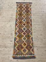 A Chobi kilim runner rug 246cm x 76cm