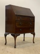 An early 20th century mahogany bureau, the fall front opening to a fitted interior, above three