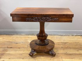 A rosewood card table, second quarter of the 19th century, the foldover and revolving top opening to