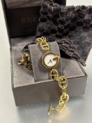 A ladys Gucci gilt metal quartz wrist watch with G shaped mother of pearl inset dial on adjustable